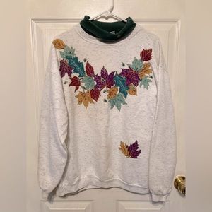 Fall leaves sweatshirt green collar. Leaves on one sleeve. Good condition.